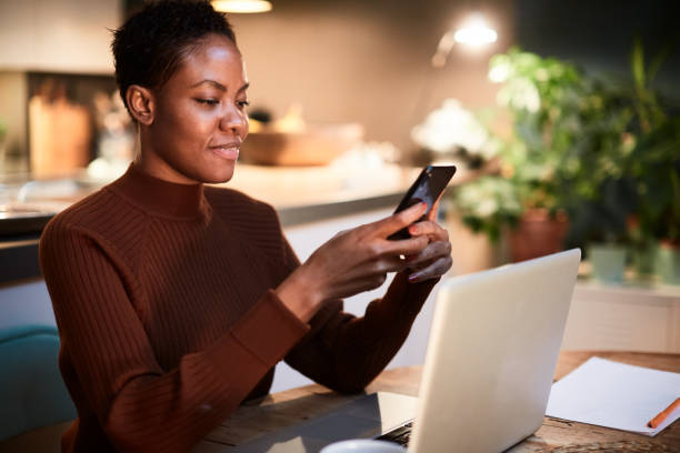 istock Woman working from home, sending an sms with a mobile phone. 1162928062