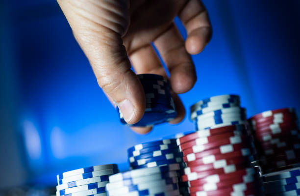 istock Successful man stacking poker chips at the casino 1162928680
