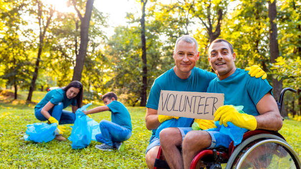 istock Volunteers: Family cleans up their community park. 1162930670