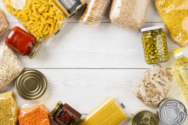 Photo of Various uncooked cereals, grains, pasta and canned food.