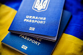Ukrainian biometric passports on the background of the Ukrainian blue-yellow flag.