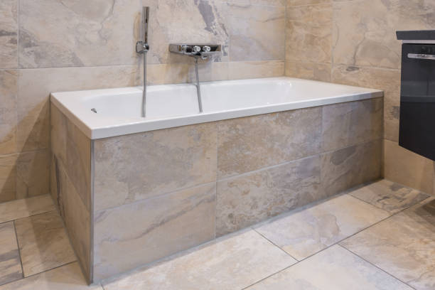 istock Modern and luxurious looking bathroom with tiled tub 1162936859
