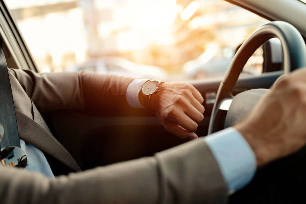 Businessman is Looking at Watch in His Car