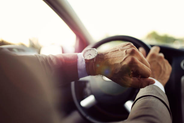 istock Businessman is Looking at Watch in His Car 1162937059