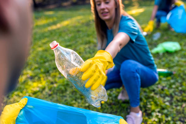 istock Woman cleaning the local park from plastic litter 1162940110