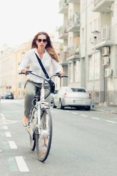 istock Woman Riding Bicycle On Road 1162941032
