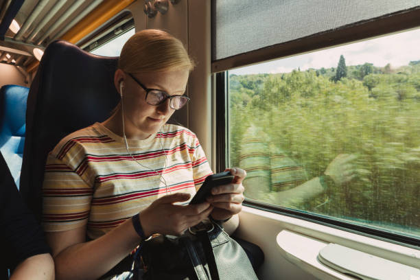 istock Young Woman Using Her Phone on the Train 1162941270