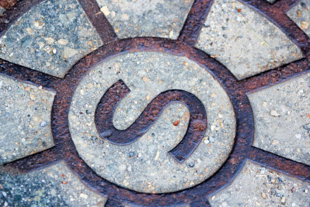 istock letter s on a manhole cover in a road 1162941272