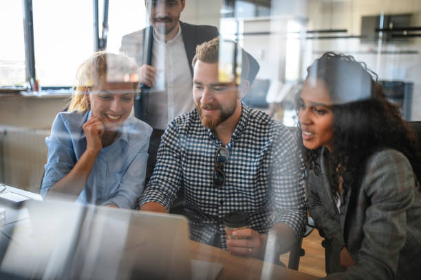 istock Young Businesspeople Working with Laptop and Sharing Ideas 1162941434