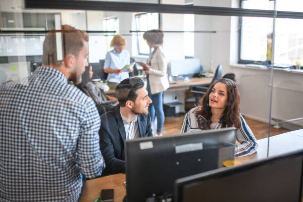 istock Business Colleagues Sitting at Workstation and Sharing Ideas 1162941457