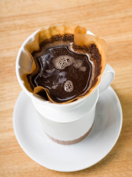 istock Top view of coffee drip set on wood background 1162944305
