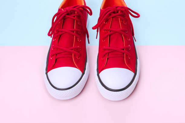 istock New red sneakers on pink and blue background with copy space. 1162951367