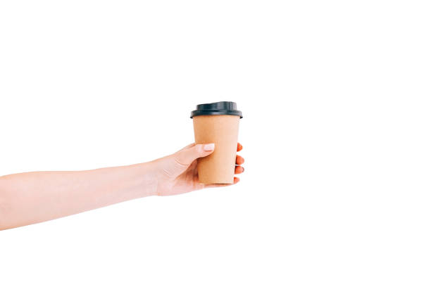 istock Paper coffee cup to go in woman's hand isolated on white. Mockup. 1162951369
