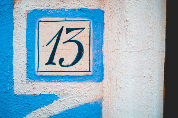 istock number 13 door sign on blue and white facade 1162952113