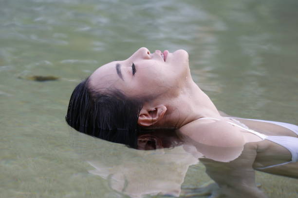 istock Smiling Young Woman In Swimming Pool 1162952675
