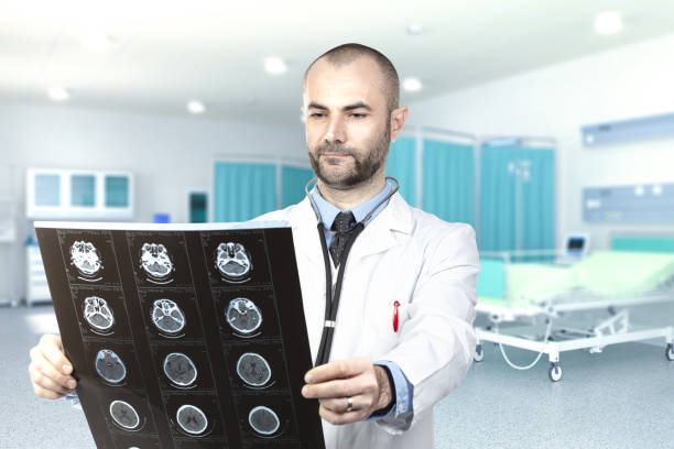 istock Doctor Examining X-Ray While Standing At Hospital 1162952749
