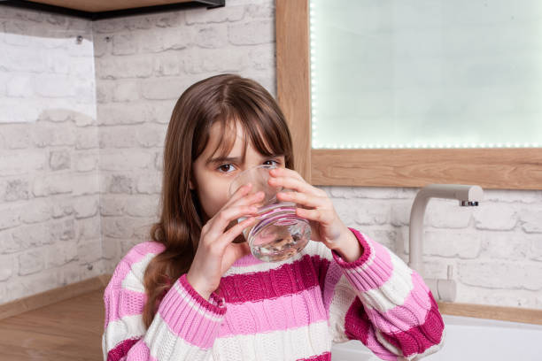 istock One beautiful Girl drinks water from a glass 1162953495