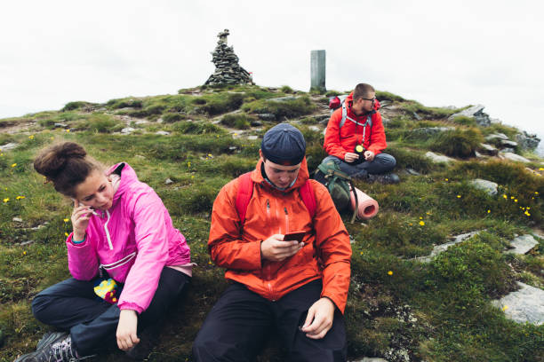 istock Friends relaxing in the mountains after hiking 1162954412