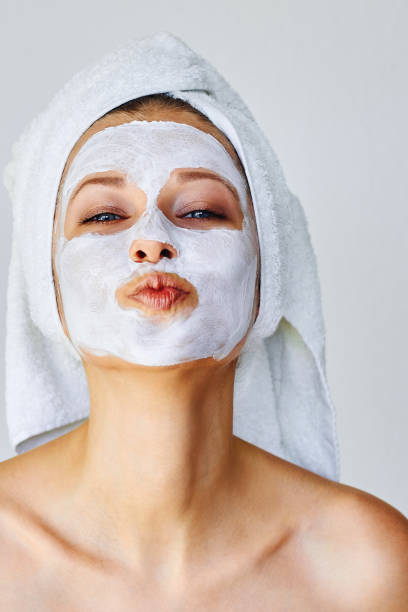 Beautiful young woman with facial mask on her face Skin care and treatment, spa, natural beauty and cosmetology concept facial mask beauty product stock pictures, royalty-free photos & images
