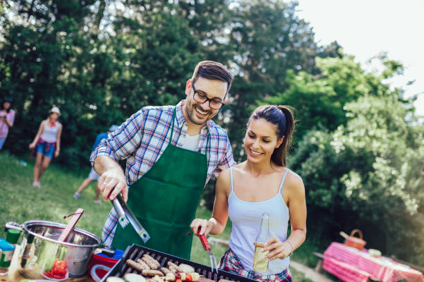 istock Young friends having fun grilling meat enjoying barbecue party. 1162954842