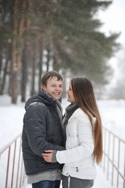 istock pair of lovers on a date winter afternoon in a snow blizzard 1162955749