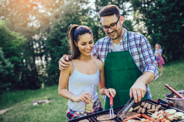 istock Young friends having fun grilling meat enjoying barbecue party. 1162956908