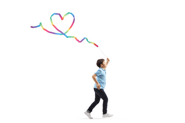 istock Boy running with a rhythmic ribbon and making a heart shape 1162957266