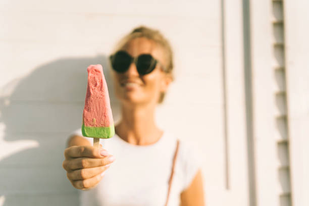 istock Closeup of fruit popsicle in hands 1162957404