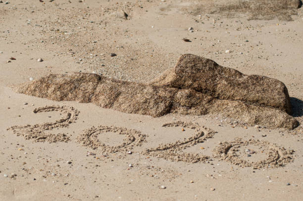 istock 2020 writing in the sand on the beach 1162958756