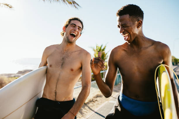 istock Cheerful friends going water surfing on holiday 1162958967