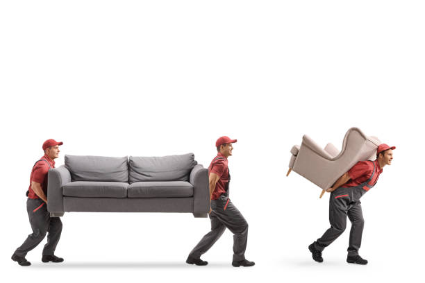 istock Movers carrying a couch and an armchair 1162959777