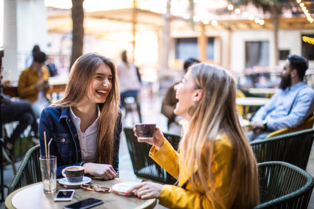 istock Besties laughing while drinking coffee outdoor 1162960299
