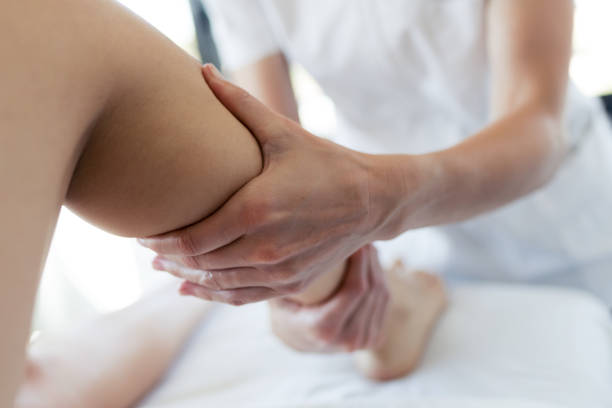 Masseur massaging the pregnant woman's legs in spa center. Close-up of masseur massaging the pregnant woman's legs in spa center. blood flow stock pictures, royalty-free photos & images