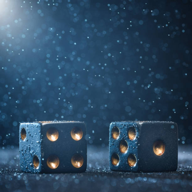 istock Two black dices illuminated by bright light on a blue background. The concept of gambling. 1162962818