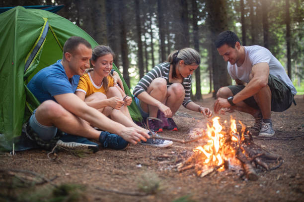 istock Couple playing around a camp fire together 1162963583
