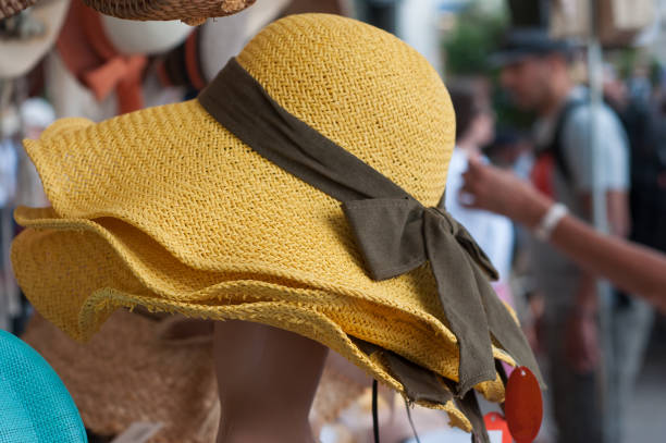closeup of yellow summer hats at the market