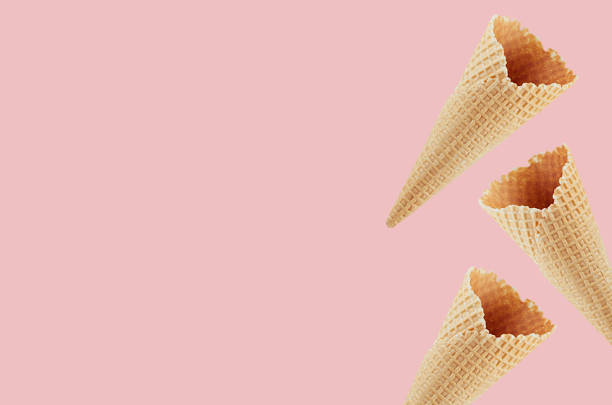 istock Empty ice cream cones as decorative border on pastel pink background, mock up for advertising, design, menu. 1162965629