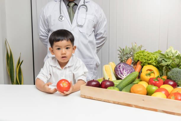 istock Cute Boy With Fresh Food In Doctor Office 1162968391