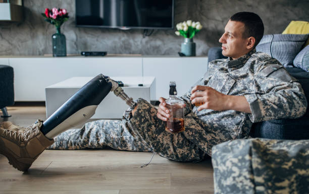 istock Disabled US soldier drinking whiskey in living room alone 1162969189