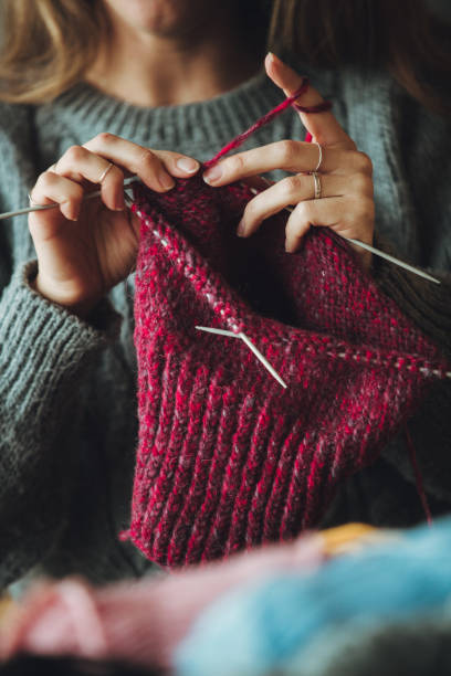 istock Close up on woman's hands knitting 1162970281