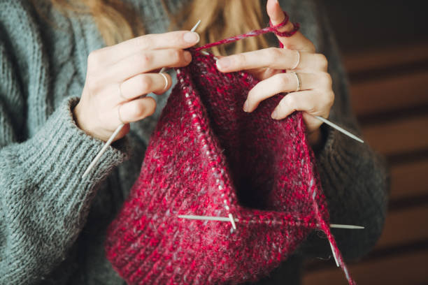 istock Close up on woman's hands knitting 1162970282