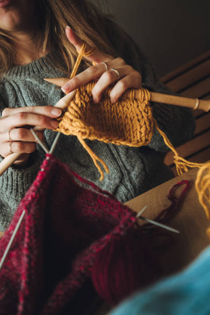 istock Close up on woman's hands knitting 1162970287