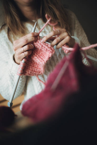 istock Close up on woman's hands knitting 1162970290