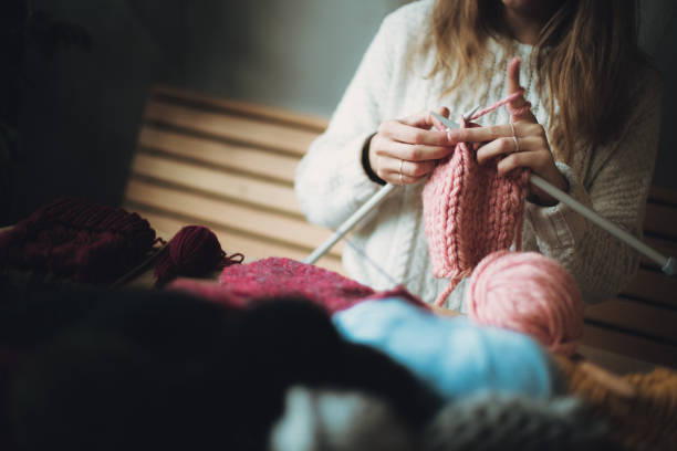 istock Close up on woman's hands knitting 1162970306