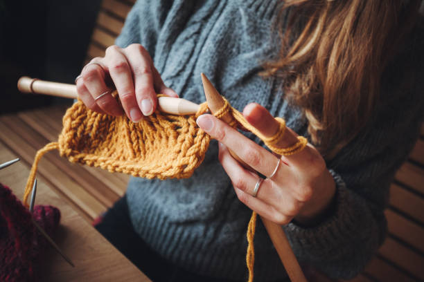 istock Close up on woman's hands knitting 1162970308