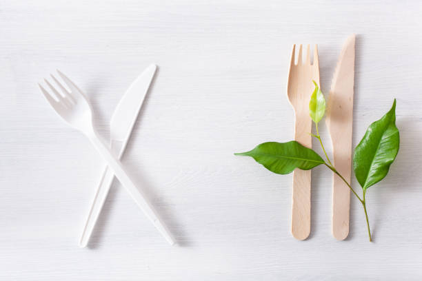 istock harmful plastic cutlery and eco friendly wooden cutlery. plastic free concept 1162970436