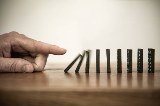Domino Falling dominoes | Domino effect clean and jerk stock pictures, royalty-free photos & images