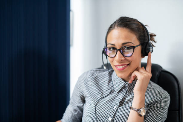 istock Businesswoman wearing headset in office. 1162971814