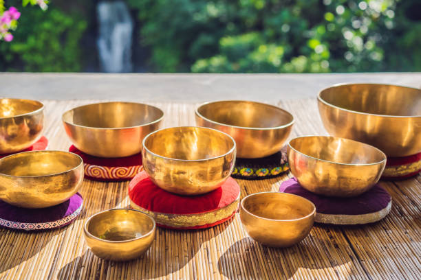 istock Tibetan singing bowls on a straw mat against a waterfall 1162972277