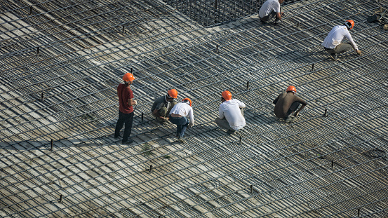 Builders at the construction work with fittings